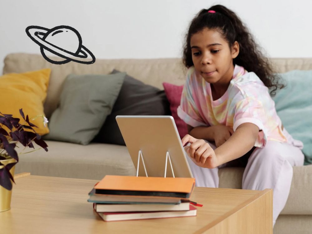 A girl sitting on her couch and tapping on the iPad